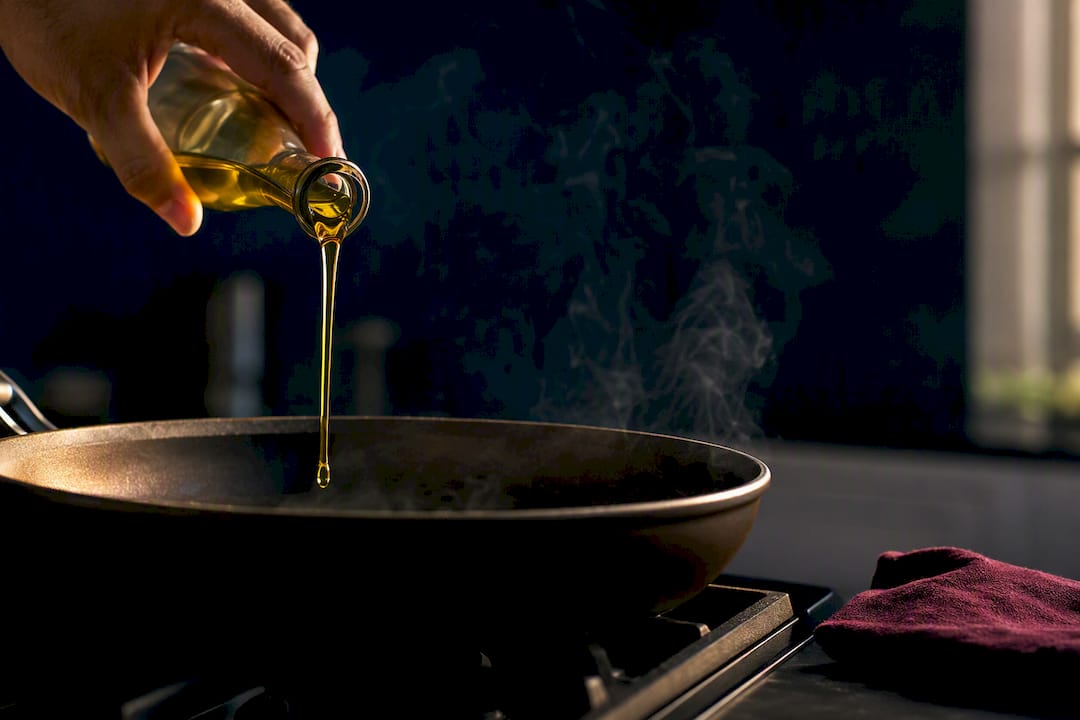 Olive oil heating in a sauté pan