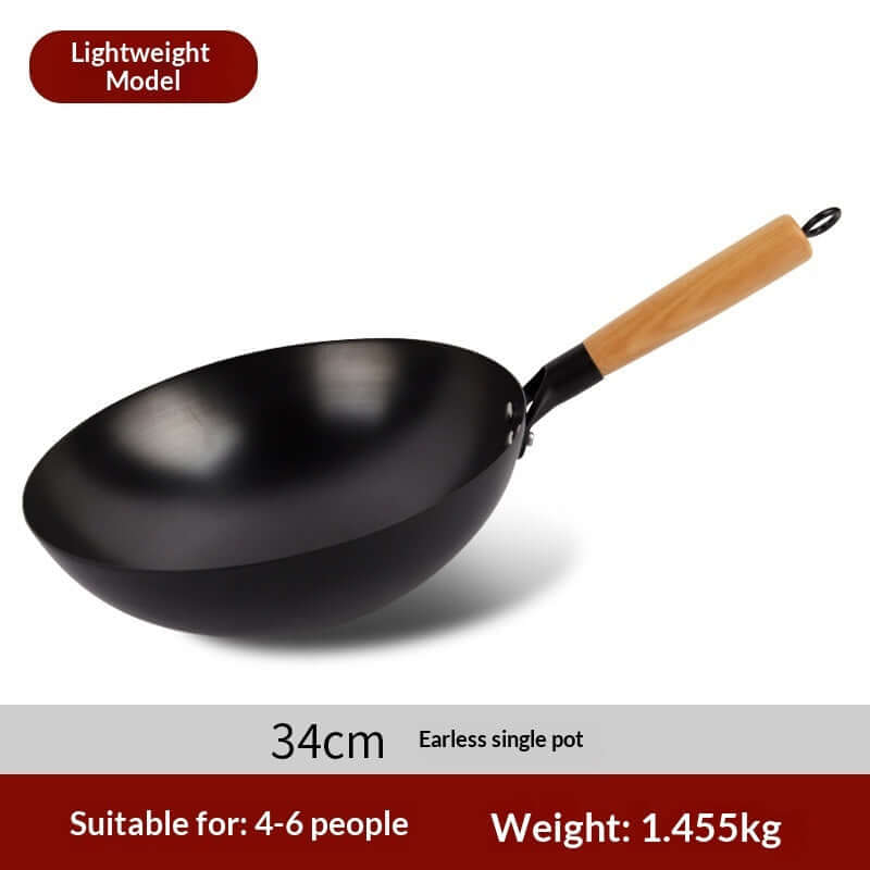 Wrought iron wok in use over high heat