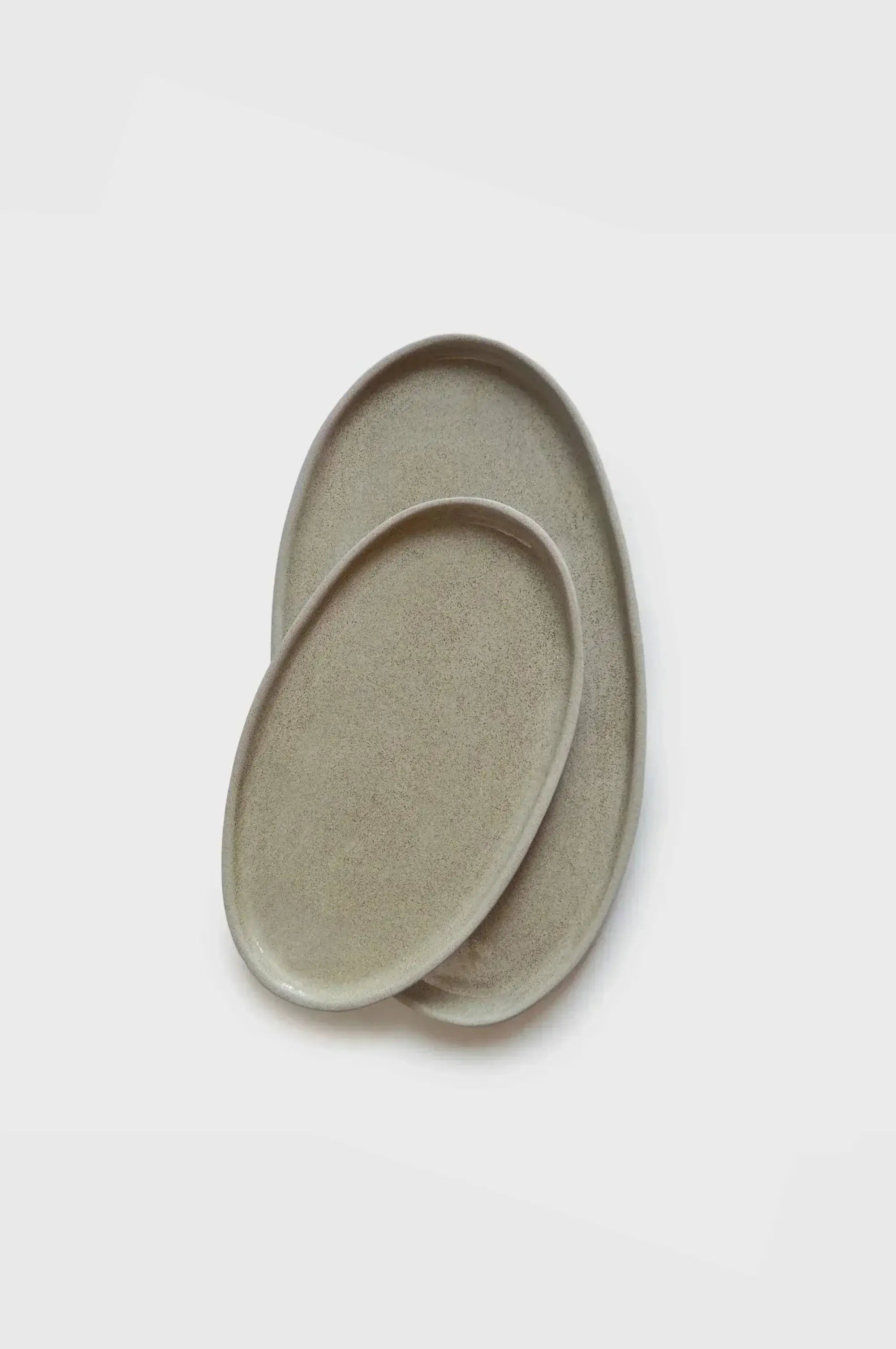 Handmade stoneware serving platter in a unique concrete style with polished and textured surfaces.