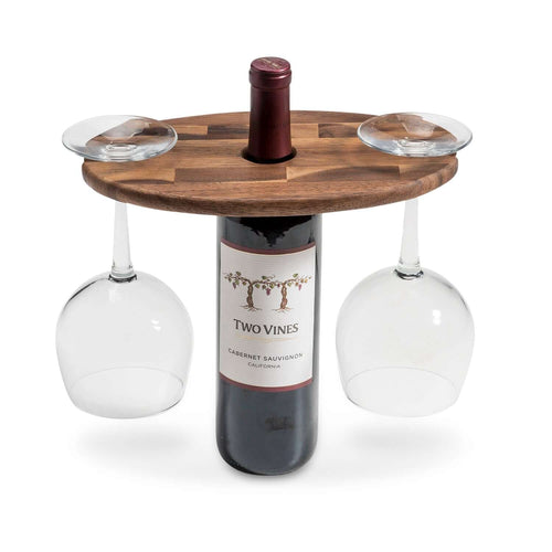 Acacia wood wine glass caddy holding two wine glasses on top of a wine bottle for elegant serving.