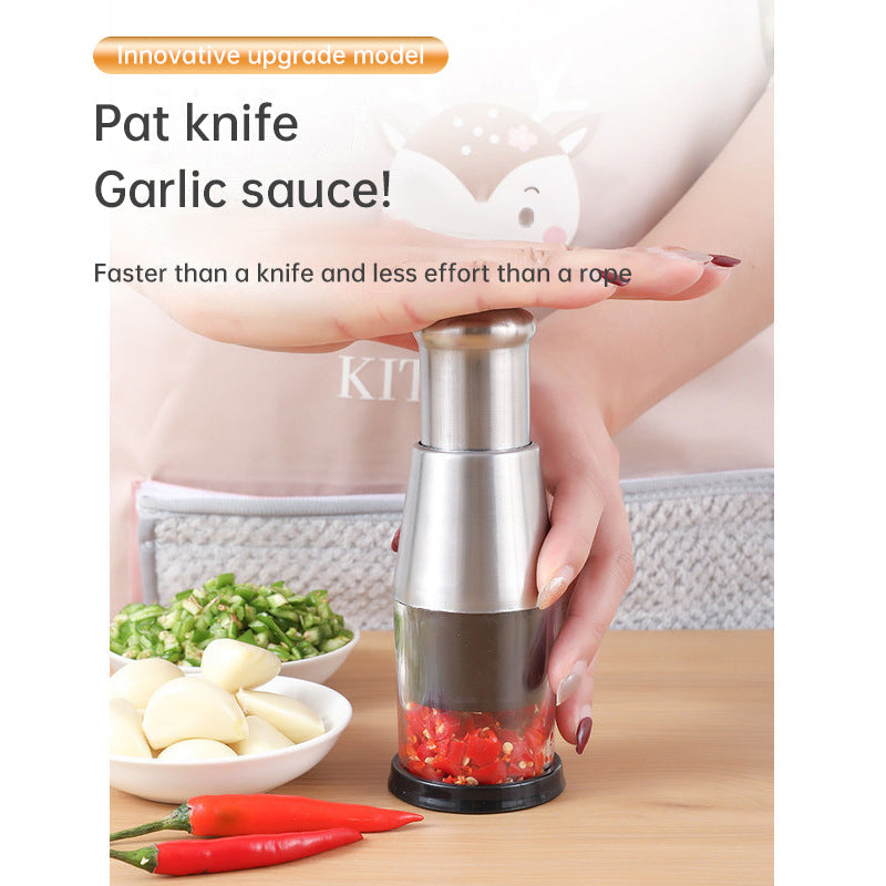 Manual Garlic Chopper, Stainless Steel, Press-Down Plunger, in use with garlic and chili - Wine Drop Cookery LLC