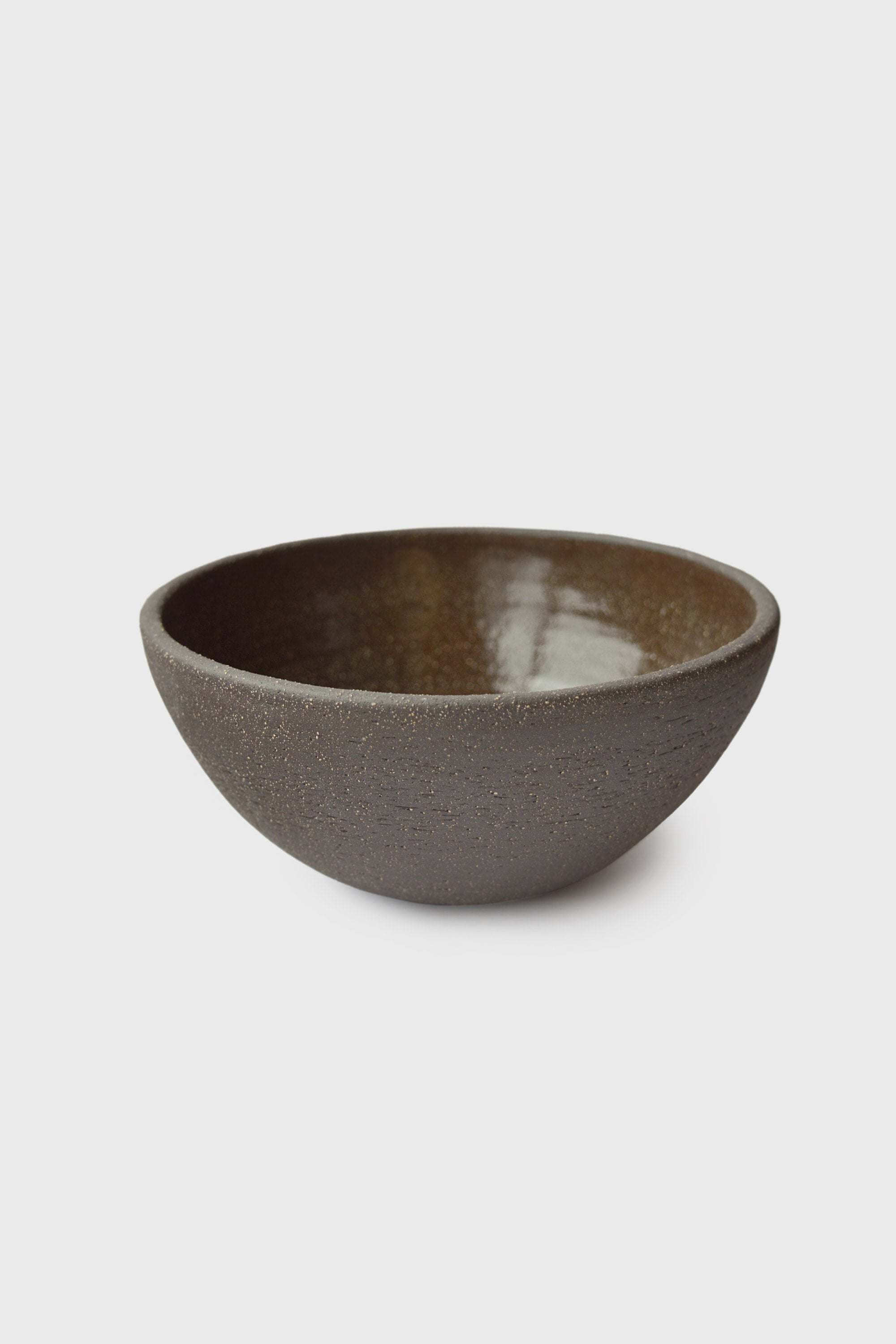 Handmade Dark Stoneware Bowl Pumpernickel Handmade dark stoneware serving bowl "Pumpernickel" featuring a textured exterior and glazed interior.