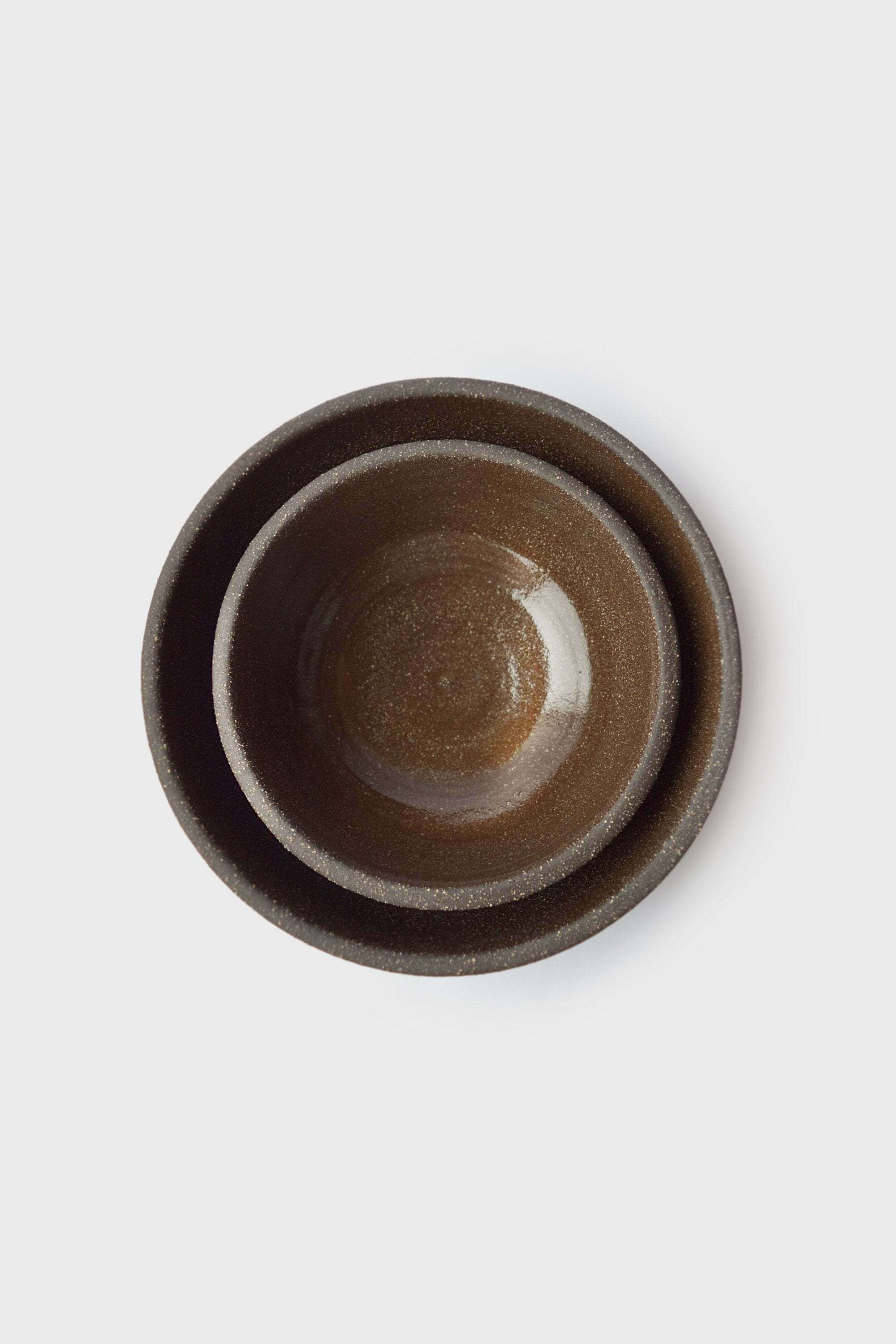 Handmade Dark Stoneware Bowl Pumpernickel Handmade dark stoneware serving bowl set with glossy interior, ideal for serving food.