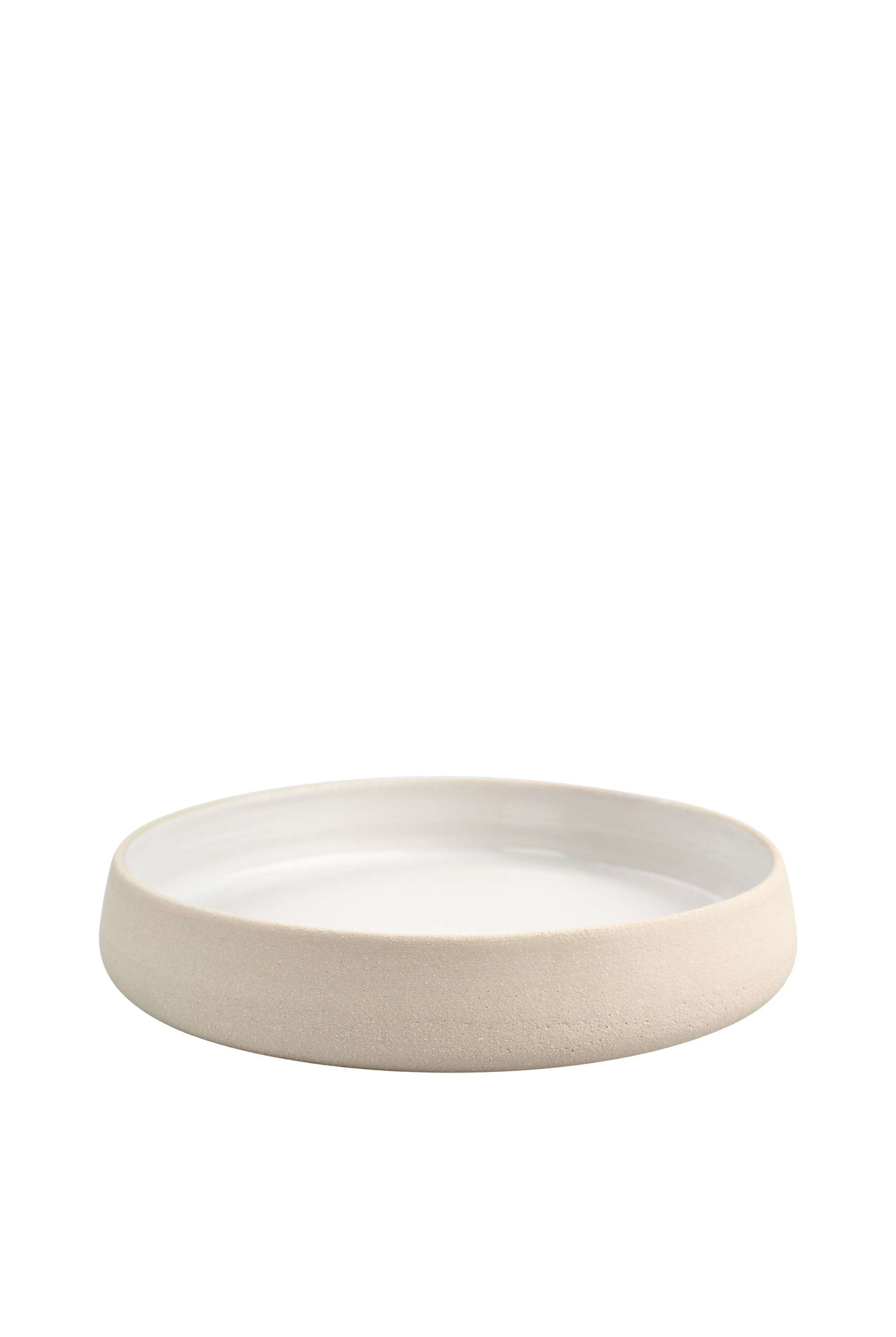 Handmade stoneware dinner plates with high sides featuring a textured exterior and smooth gloss white interior.