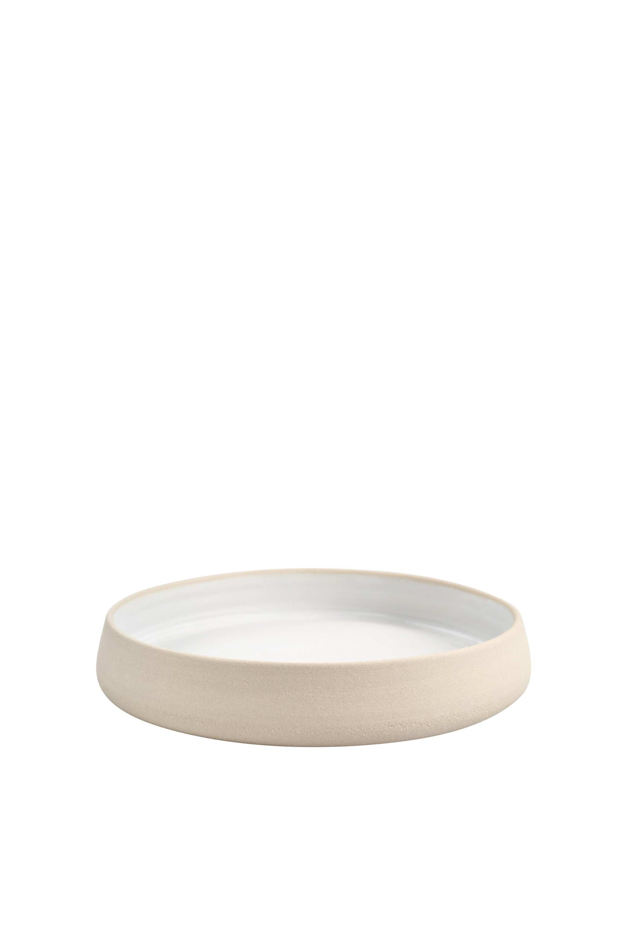 Handmade stoneware dinner plates with high sides, showcasing a textured exterior and smooth white glaze interior.