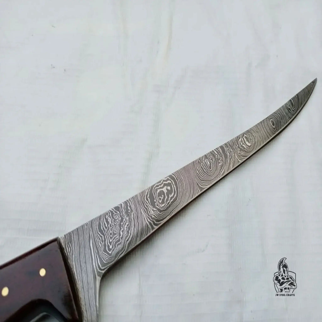 Custom made damascus fillet knife with a detailed blade design for precision filleting.