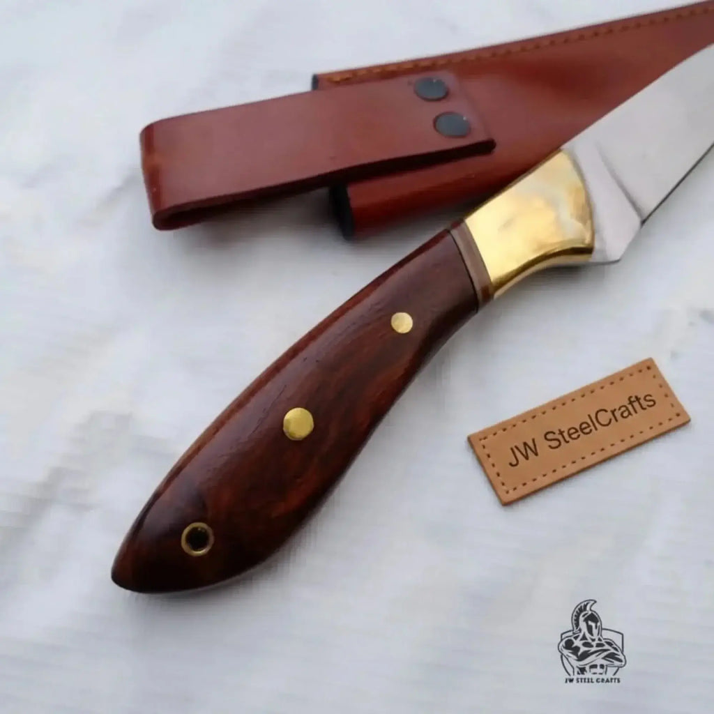 Handmade fillet knife rosewood handle with a curved blade and brass accents, displayed with a leather sheath.