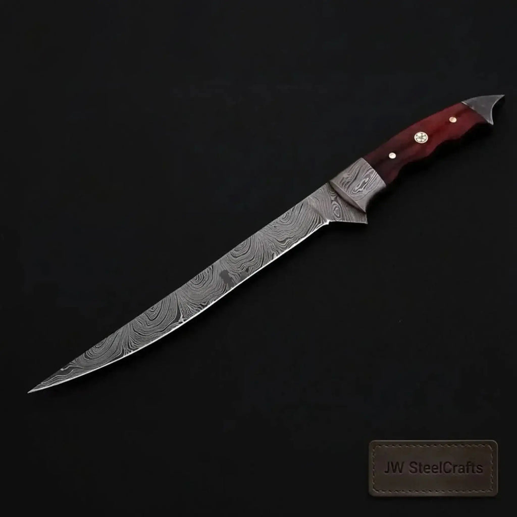 Handmade Damascus fillet knife with flexible blade and hardwood handle on a dark background.