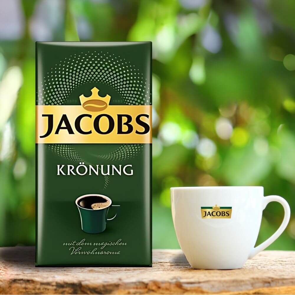 Jacobs Krönung Ground Coffee 17.6oz Premium German Roast packaging with cup of coffee.