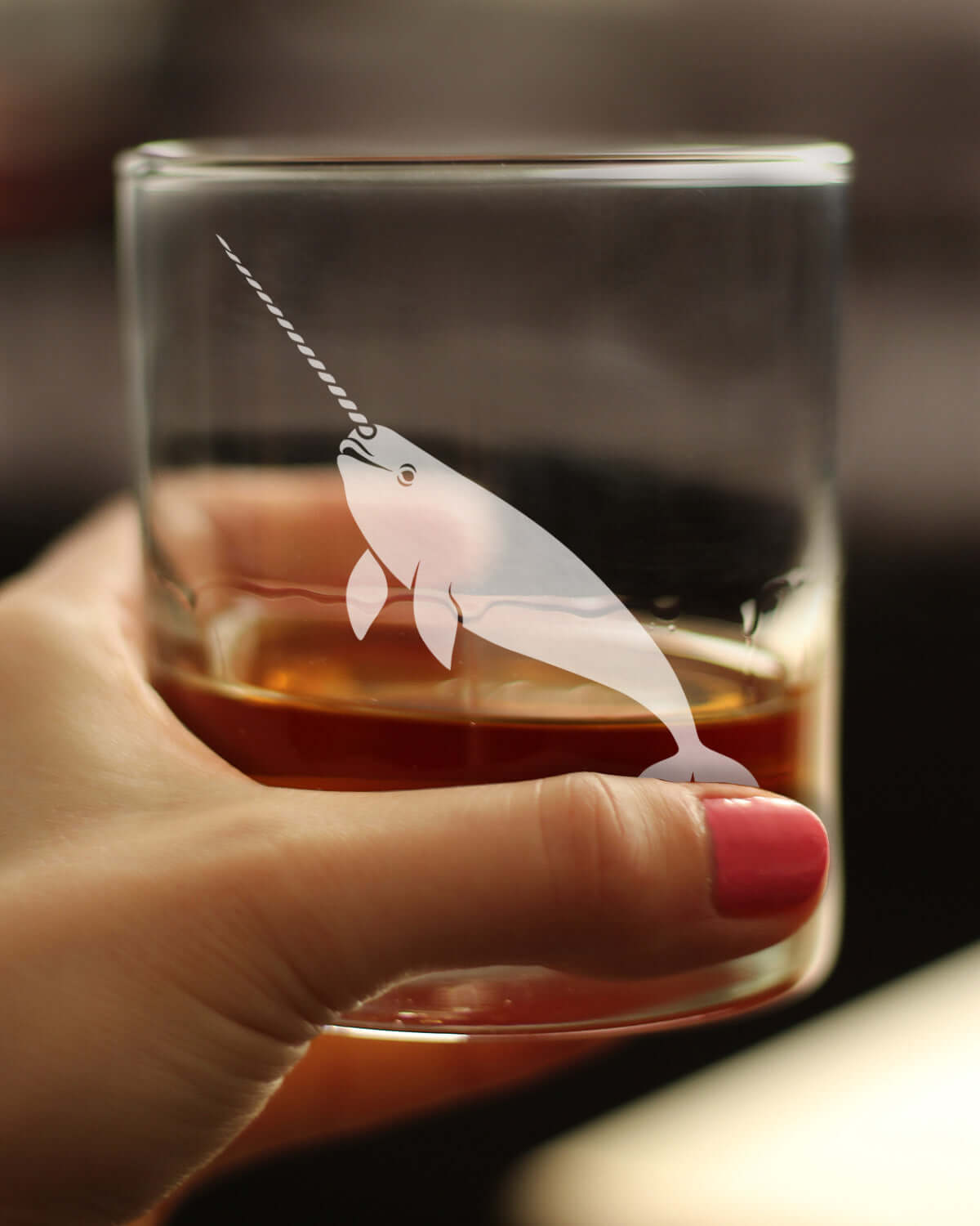 Narwhal engraved rocks glass in hand, showcasing unique etching, ideal for whiskey lovers and perfect narwhal gifts for women.