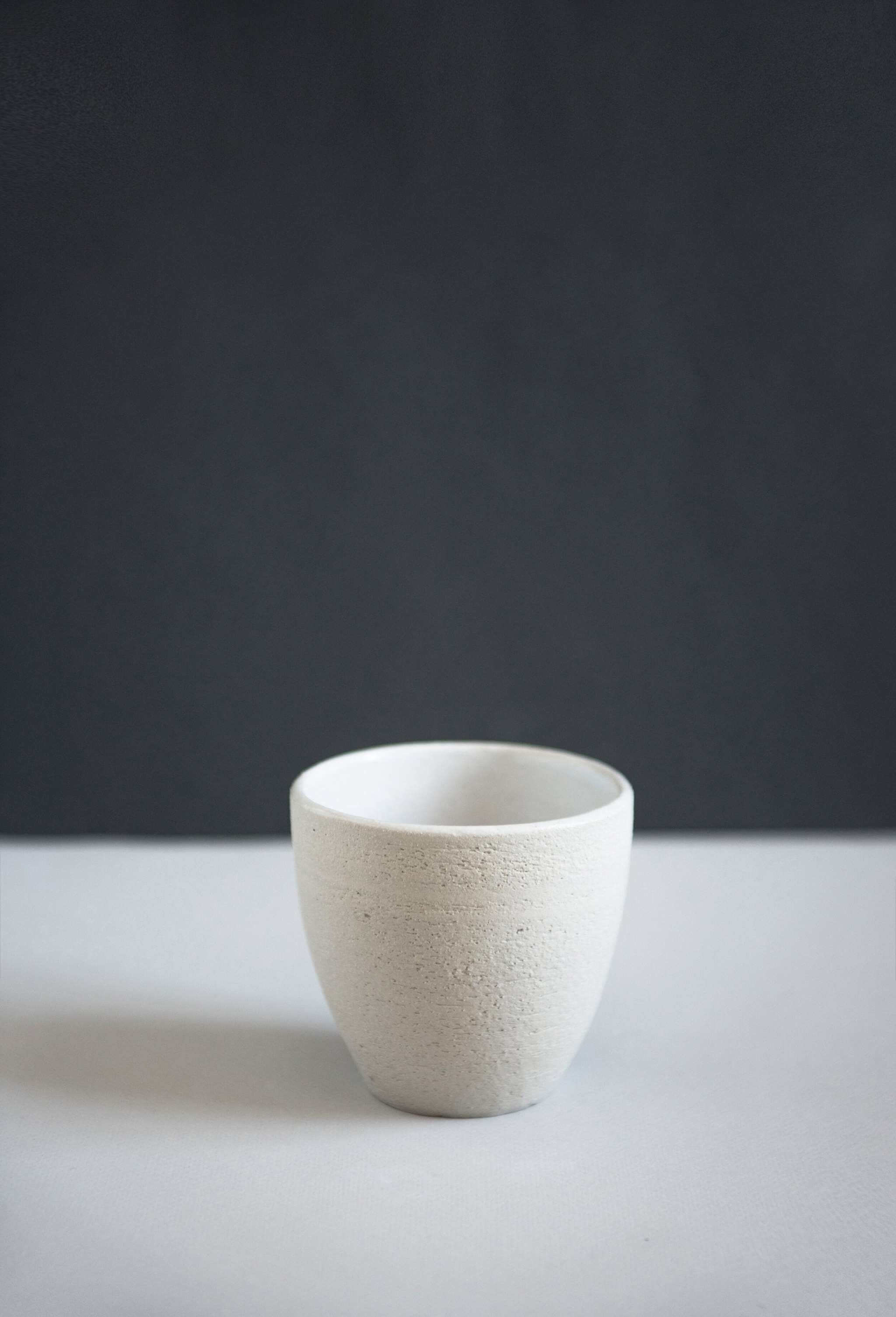 Handmade Stoneware -Coffee Cup Handmade stoneware coffee cup with rough exterior and smooth interior, showcasing artisan craftsmanship.