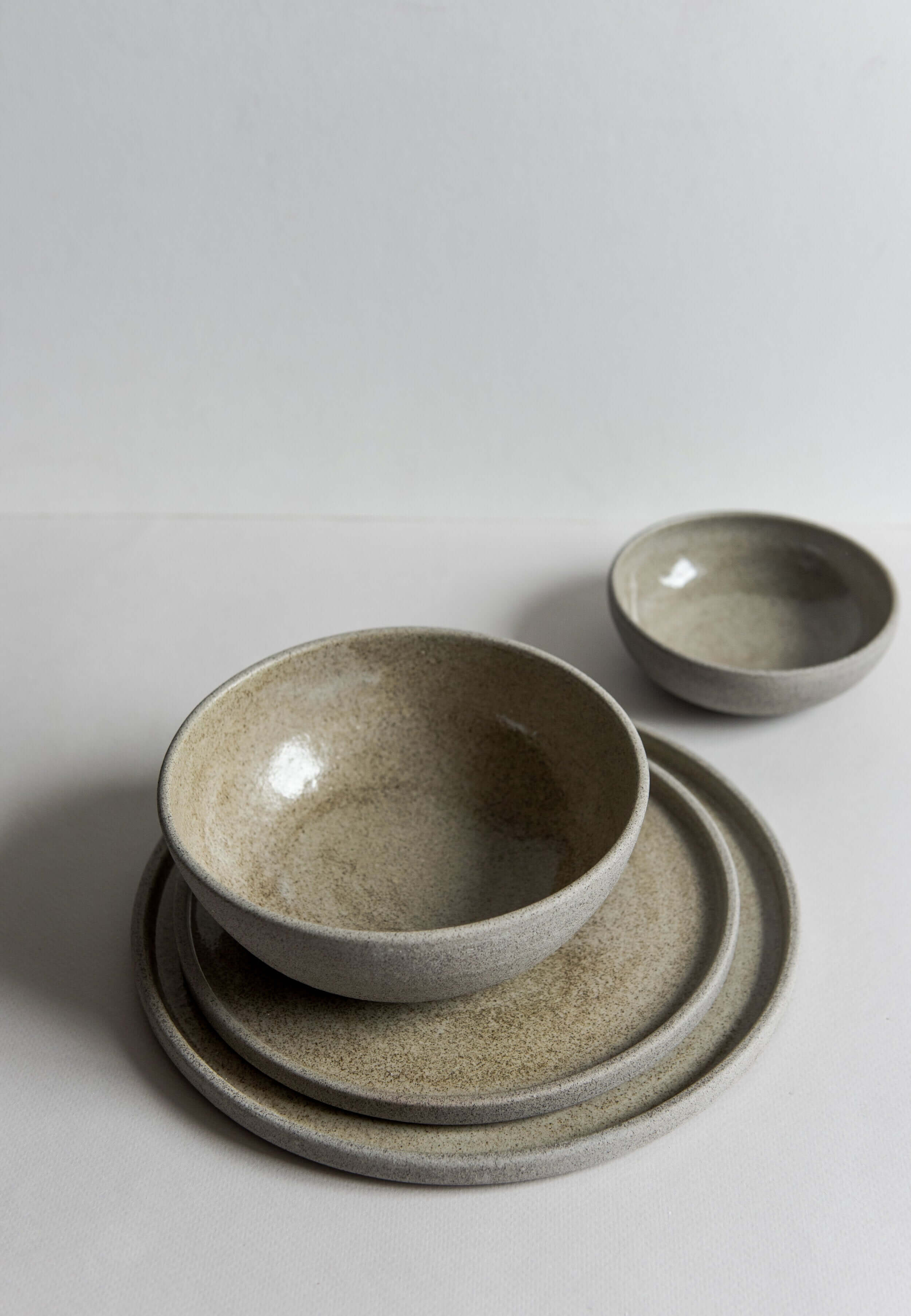 Stoneware dinner plates concrete with textured surface and glossy interior, featuring rustic style dinnerware.