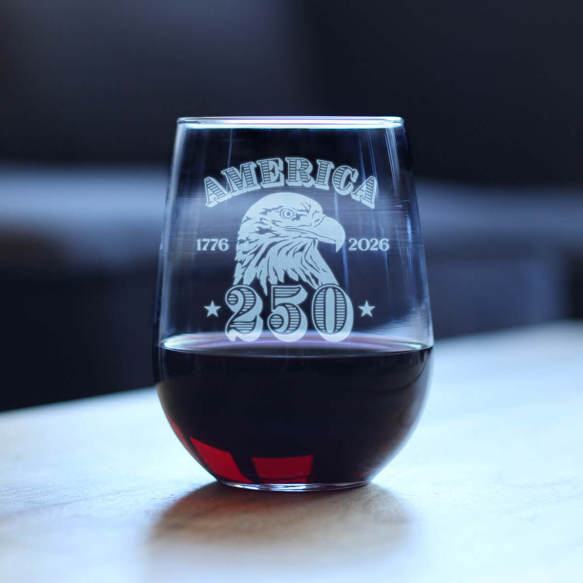 Engraved stemless wine glass 250th anniversary featuring eagle design and red wine, celebrating America's 250 years.