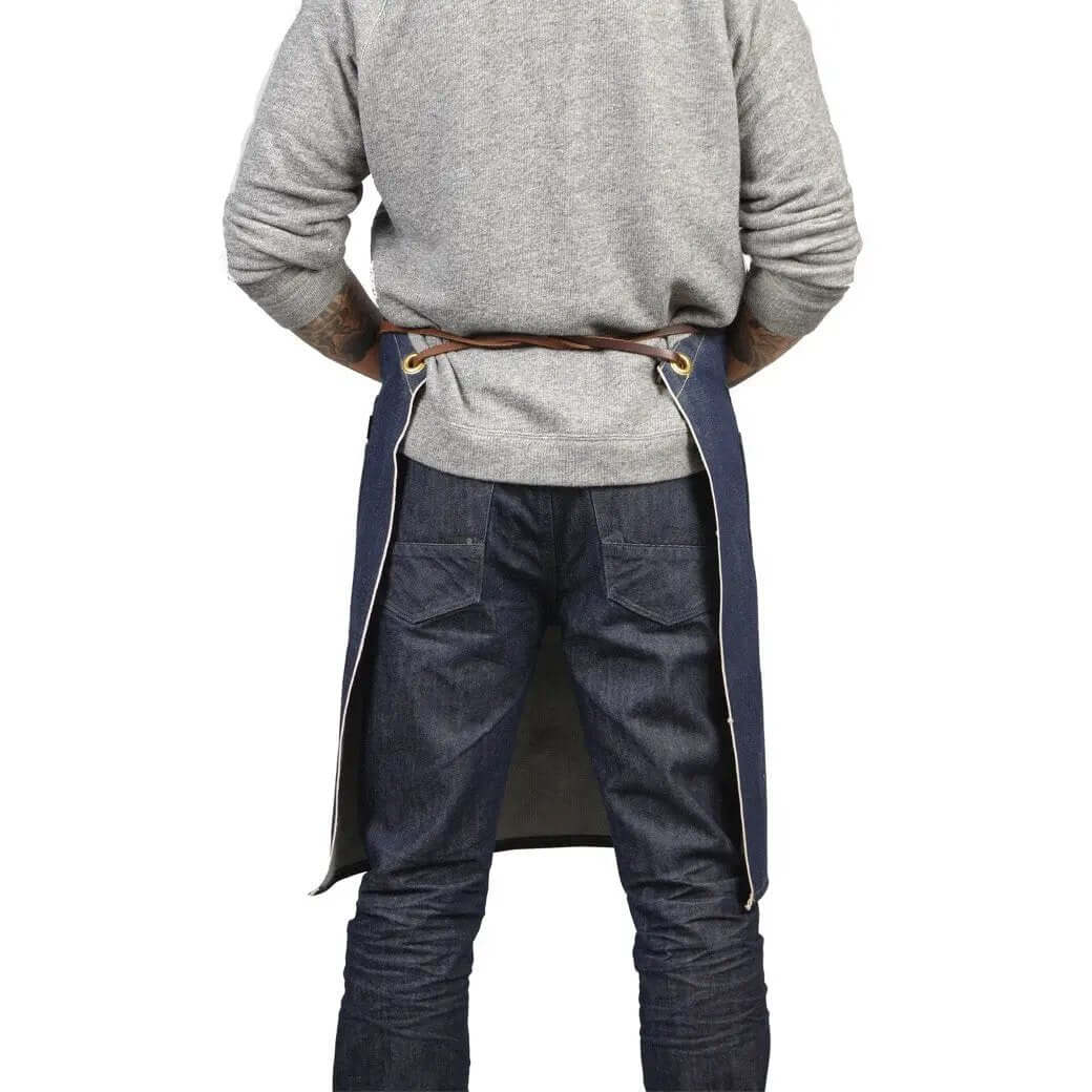 Man wearing the selvedge apron with removable leather, featuring a latigo leather strap and denim design.
