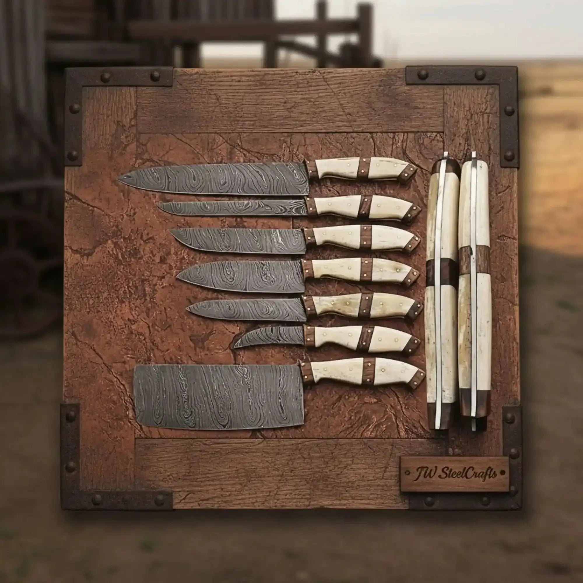 7-piece Damascus kitchen knife set displayed on a wooden board, featuring various knife types with bone handles.