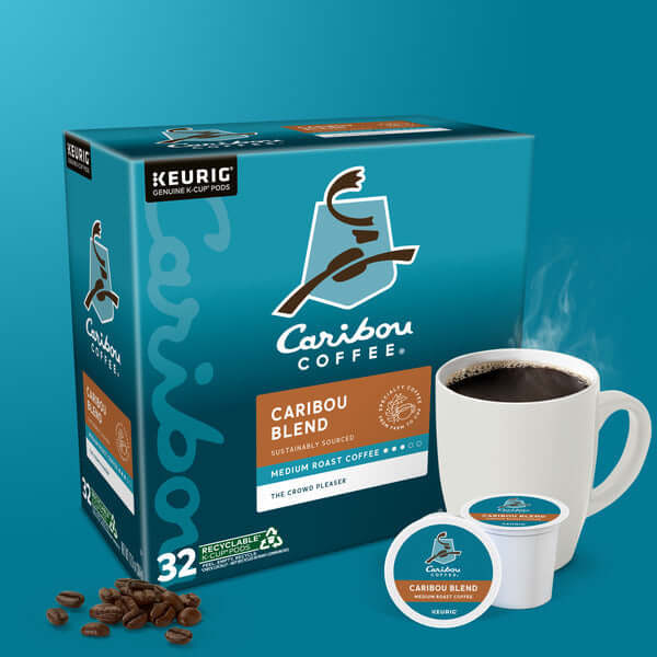 Caribou Coffee Caribou Blend K-Cup Pods packaging with brewed coffee cup and coffee beans.