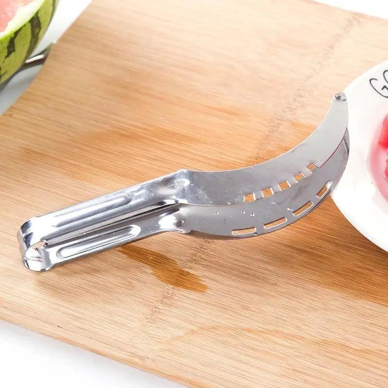Stainless Steel Watermelon Slicer or Melon Baller, slicer on a cutting board - Wine Drop Cookery LLC