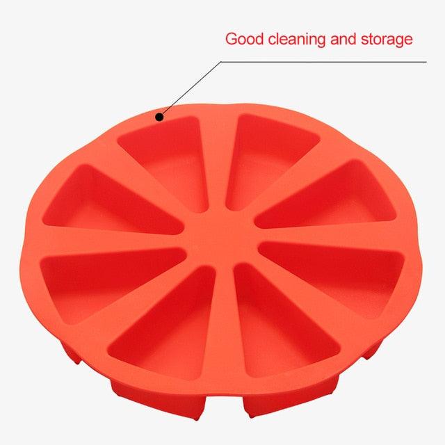 Red silicone scone mold with eight triangular cavities on a white background