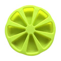 Green silicone mold with wedge-shaped cavities on a white background