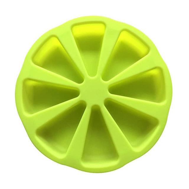 Green silicone mold with wedge-shaped cavities on a white background